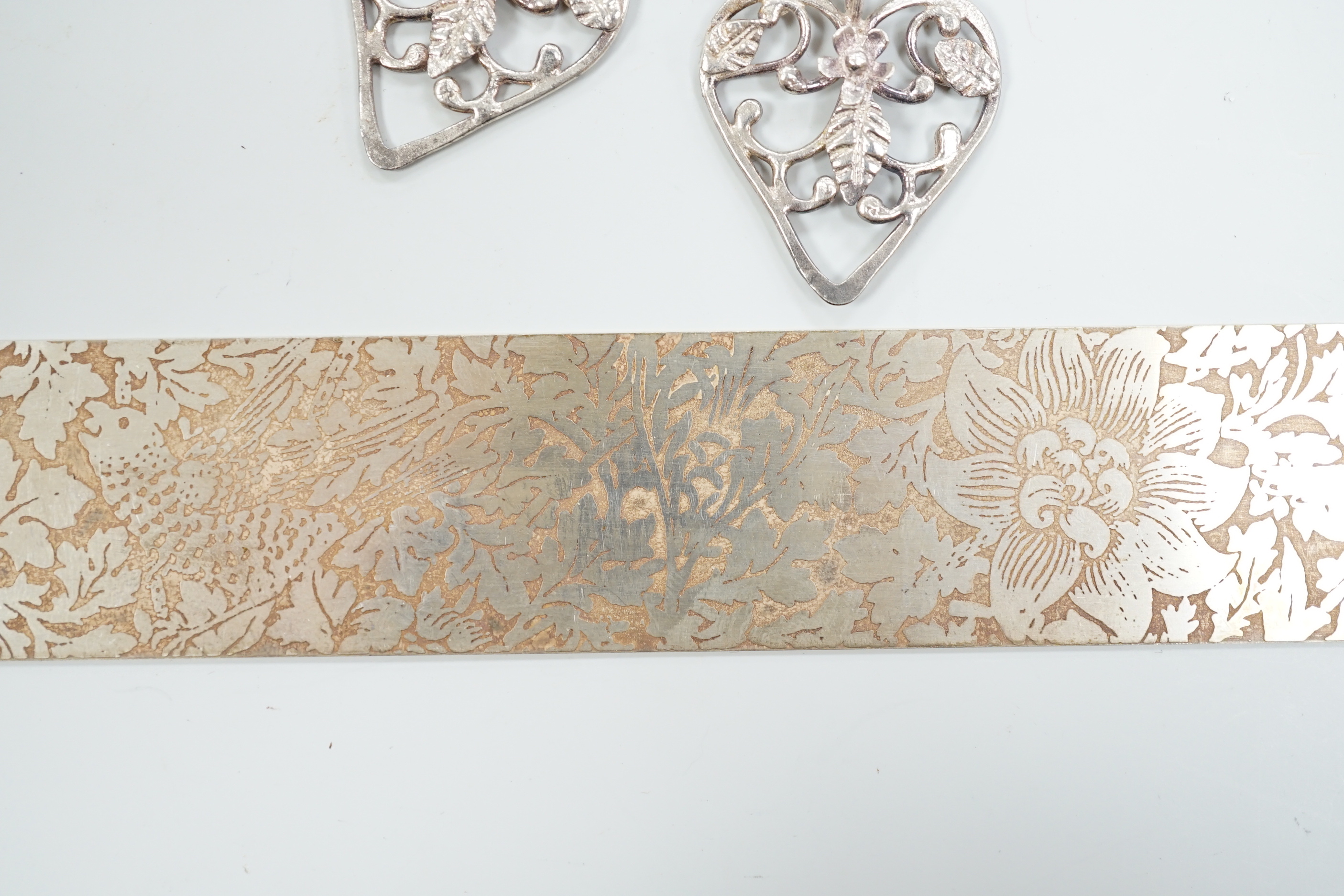 Three Pruden Smith bangles including triple loop, two other silver bangles, a white metal heart bracelet and one other bracelet, together with a straight edge rule by Mary Ann Simmons.